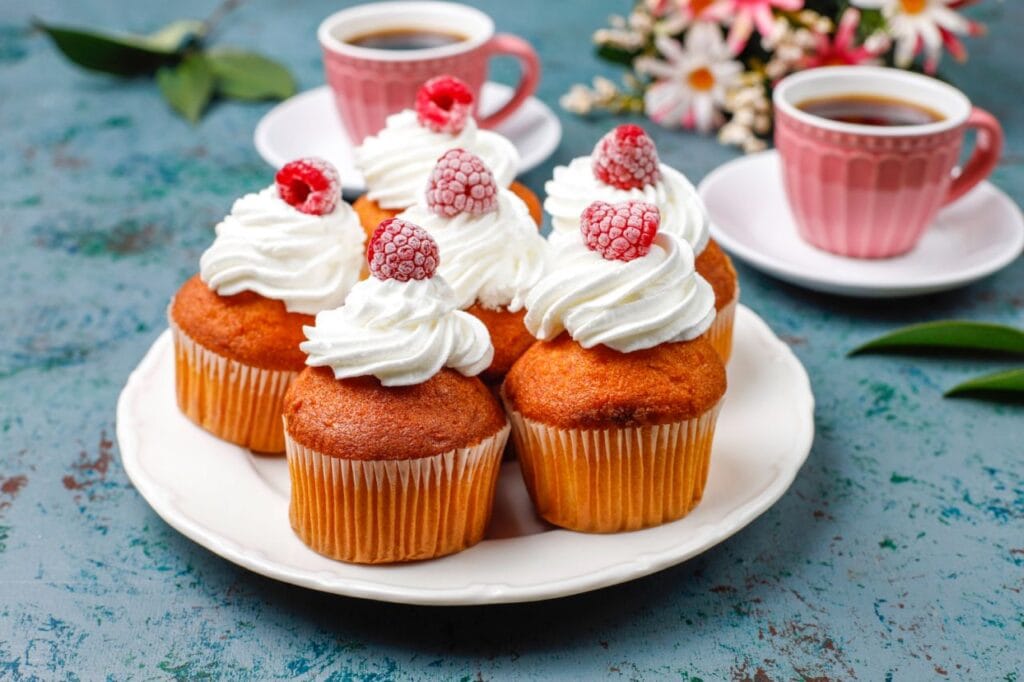 cupcakes decorated whipped cream frozen raspberries