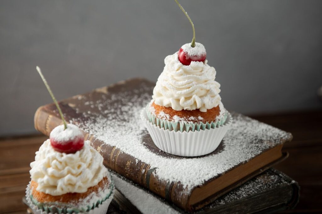 shot delicious cupcakes with cream powdered sugar cherry top books
