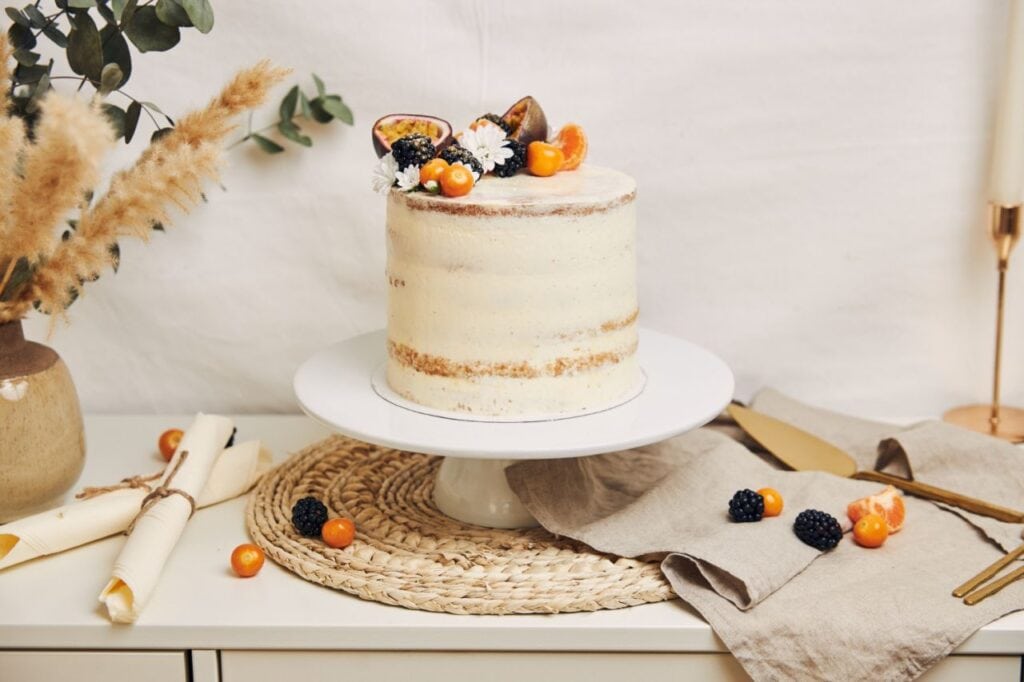 white cake with berries passionfruits plant white